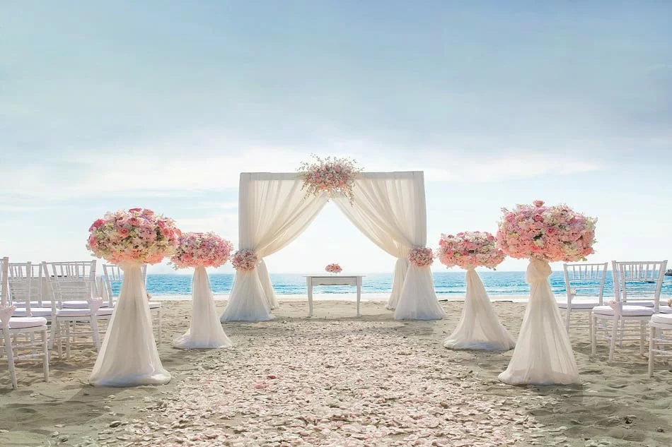 Elias beach venue setup with pink flowers for wedding