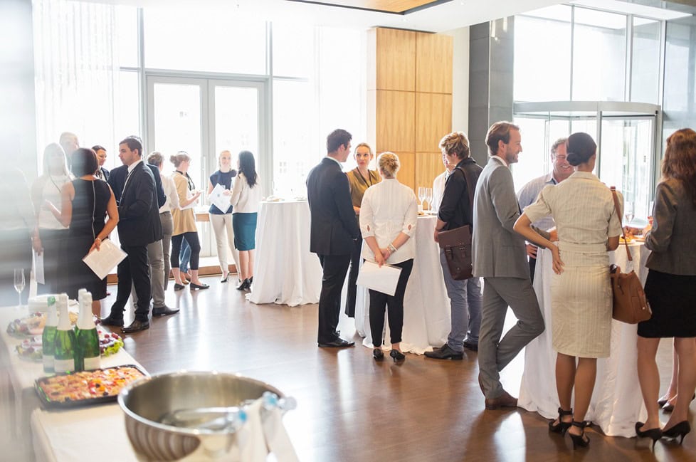 cocktail party in a large room with buffet
