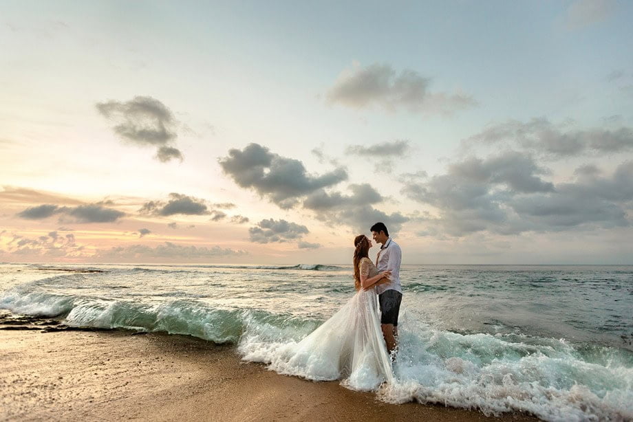 wedding couple embracing on the beach