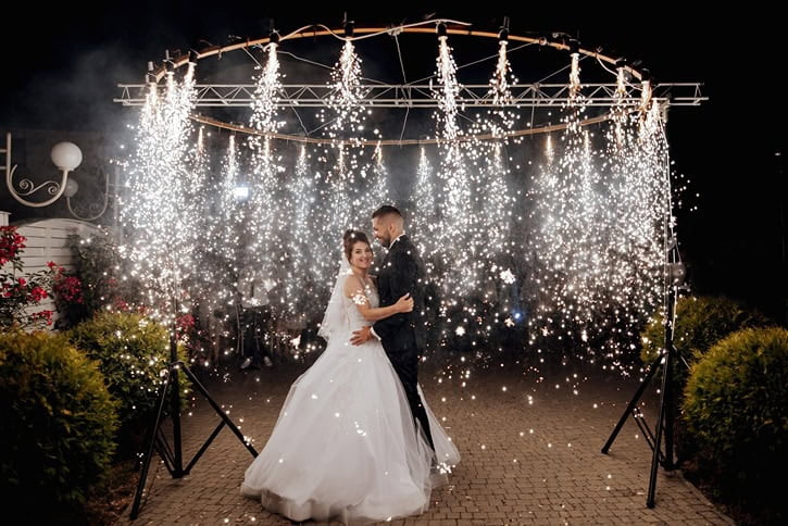 a wedding couple's first dance amidst a shower of light