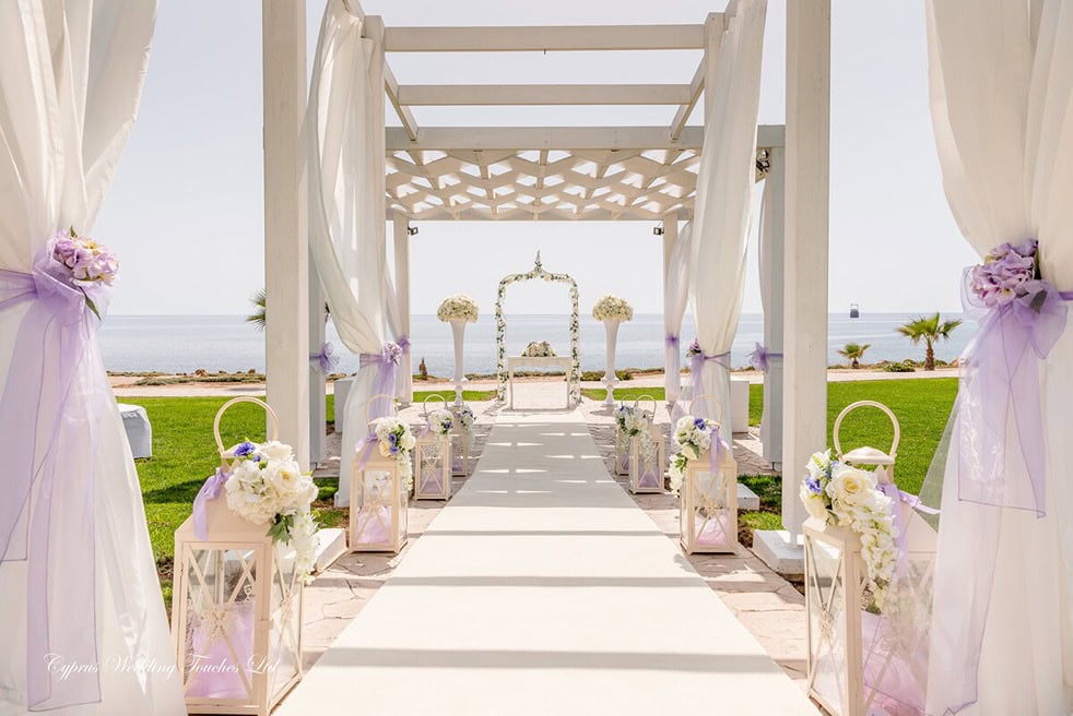 King Evelthon venue set up for wedding with white and purple walkway